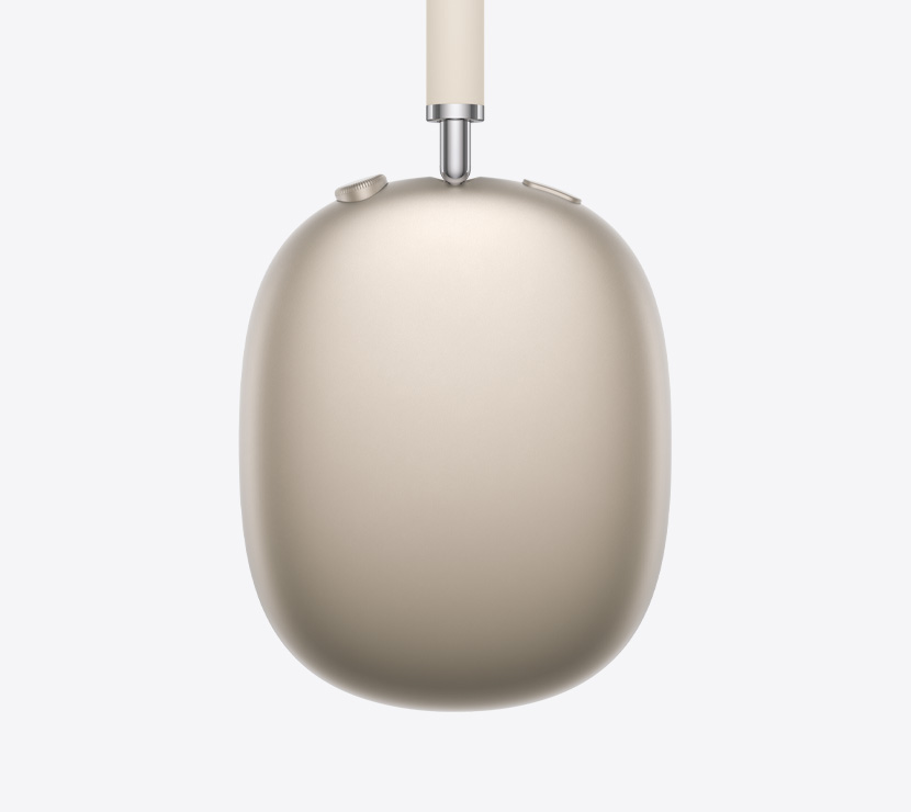 Ausinės „AirPods Max 2“, šoninė išorinė pusė, žvaigždžių šviesos spalvos, teleskopinės rankenėlės detalė, pagalvėlė, „Digital Crown“ ir triukšmo valdymo mygtukas