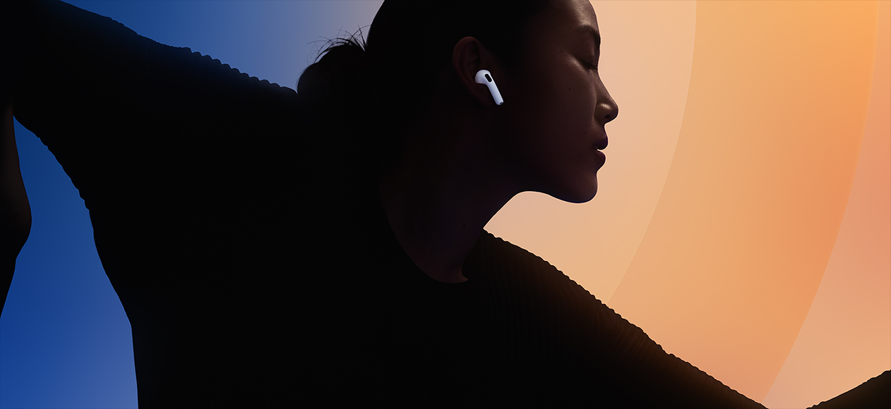 AirPods 5, color blanco, puestos en el oído, silueta de una persona sobre un fondo de muchos colores