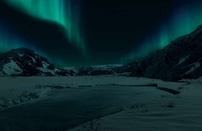 Vue de l’Apple Vision Pro d’un environnement islandais, montagnes enneigées et aurore boréale sur fond sombre
