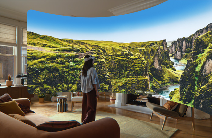 Apple Vision Pro view, a panoramic image of rocky green cliffs with a stream cutting through them and blue sky stretching beyond the cliffs